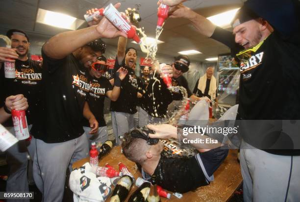 Ken Giles of the Houston Astros celebrates with teammates in the clubhouse after defeating the Boston Red Sox 5-4 in game four of the American League...