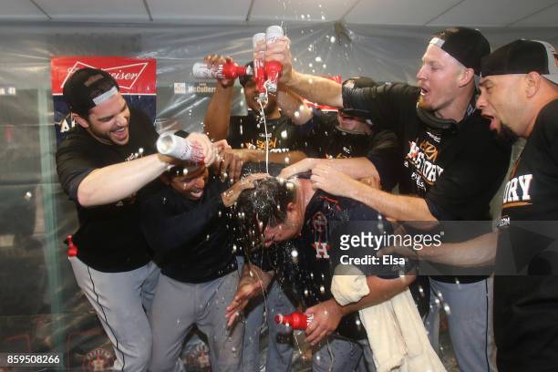 The Houston Astros celebrate in the clubhouse after defeating the Boston Red Sox 5-4 in game four of the American League Division Series at Fenway...