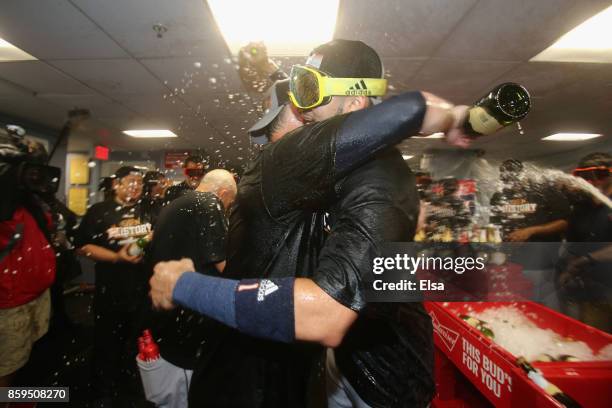 The Houston Astros celebrate in the clubhouse after defeating the Boston Red Sox 5-4 in game four of the American League Division Series at Fenway...