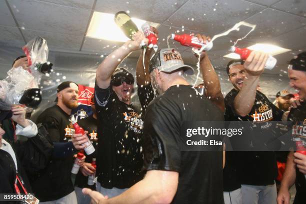 The Houston Astros celebrate in the clubhouse after defeating the Boston Red Sox 5-4 in game four of the American League Division Series at Fenway...