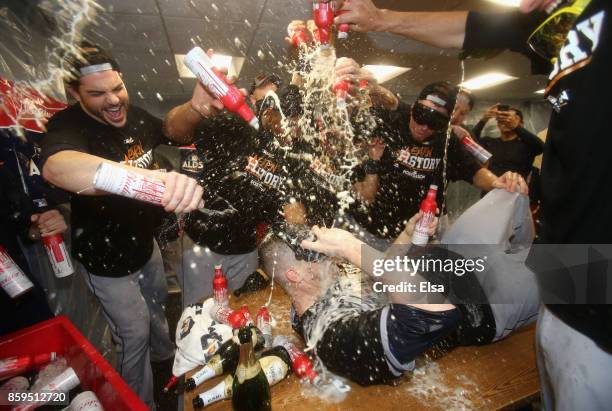 Ken Giles of the Houston Astros celebrates with teammates in the clubhouse after defeating the Boston Red Sox 5-4 in game four of the American League...