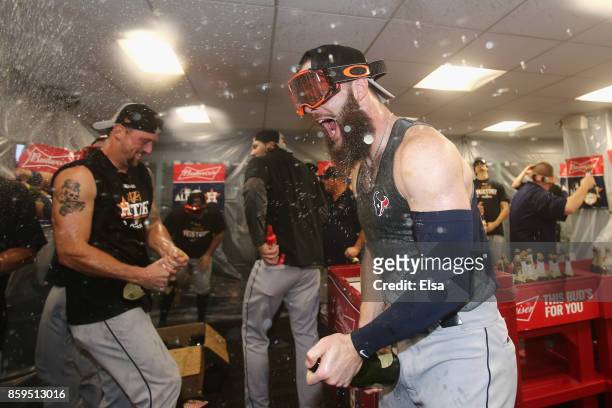 Dallas Keuchel of the Houston Astros celebrates with teammates in the clubhouse after defeating the Boston Red Sox 5-4 in game four of the American...