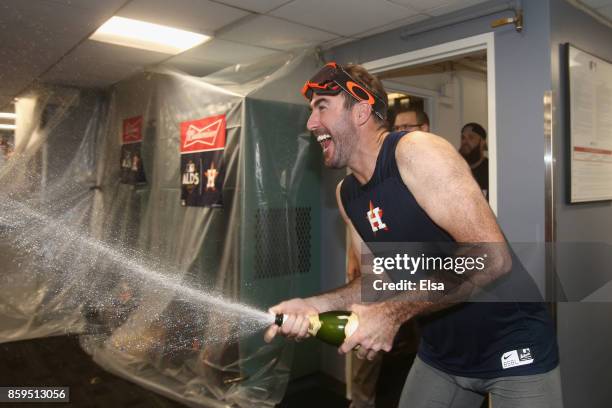 Justin Verlander of the Houston Astros celebrates with teammates in the clubhouse after defeating the Boston Red Sox 5-4 in game four of the American...