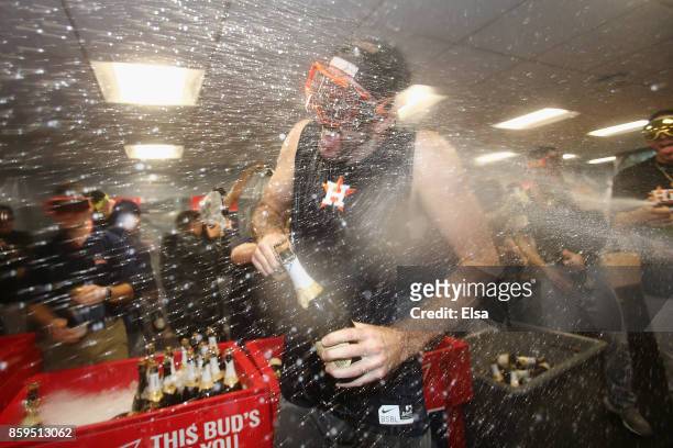 Justin Verlander of the Houston Astros celebrates with teammates in the clubhouse after defeating the Boston Red Sox 5-4 in game four of the American...