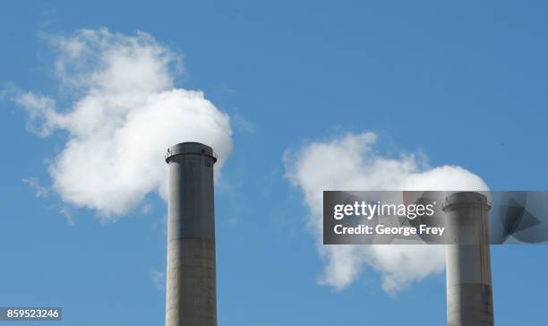 Emissions rise out of two large smoke stacks at Pacificorp's 1000 megawatt coal fired power plant on October 9, 2017 outside Huntington, Utah. It was...