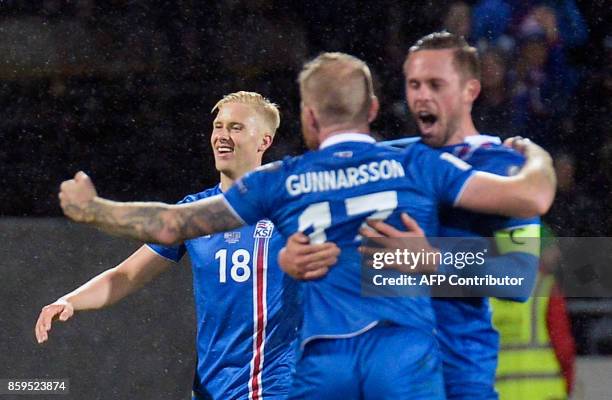 Iceland's Hordur Magnusson, Iceland's midfielder Aron Gunnarsson and Iceland's midfielder Gylfi Sigurdsson celebrate after the FIFA World Cup 2018...