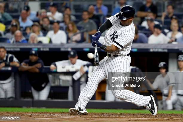 Aaron Hicks of the New York Yankees hits a single to right center field to score Todd Frazier against Trevor Bauer of the Cleveland Indians during...