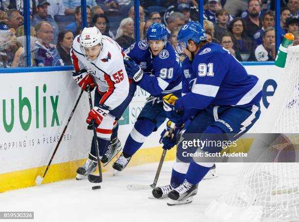 Steven Stamkos and Vladislav Namestnikov of the Tampa Bay Lightning skate against Aaron Ness of the Washington Capitals during the first period at...