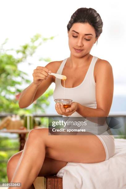 hispanic young woman getting ready for depilation wax - wax stock pictures, royalty-free photos & images