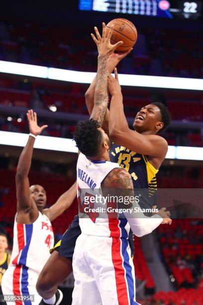 Ike Anigbogu of the Indiana Pacers tries to get a shot off over Eric Moreland of the Detroit Pistons during a pre season game at Little Caesars Arena...
