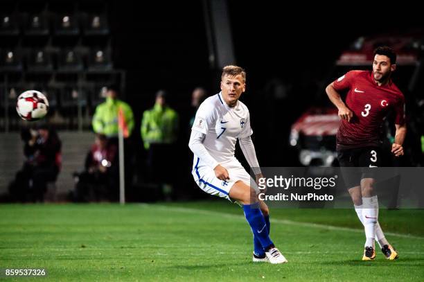 Ismail Koybasi of Turkey and Robin Lod of Finland vie for the ball during the FIFA World Cup 2018 qualifying football match between Finland and...