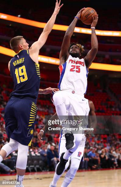 Reggie Bullock of the Detroit Pistons tries to get off a shot past Jarrod Uthoff of the Indiana Pacers during a pre season game at Little Caesars...