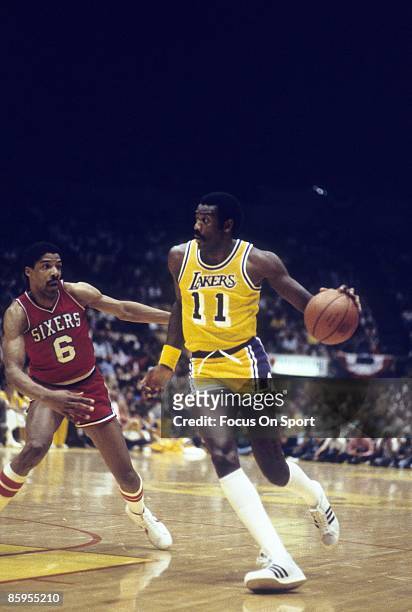 S: Bob McAdoo of the Los Angeles Lakers drives pass Julius Erving of the Philadelphia 76ers during a mid circa 1980's NBA basketball game at the...
