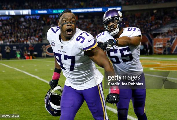 Everson Griffen and Anthony Barr of the Minnesota Vikings celebrate after Griffen stripped the football from quarterback Mitchell Trubisky of the...
