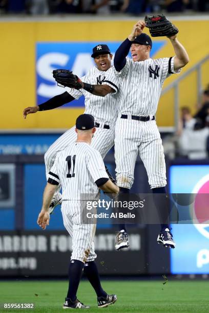 Aaron Judge of the New York Yankees celebrates with teammates Aaron Hicks and Brett Gardner after defeating the Cleveland Indians in Game Four of the...