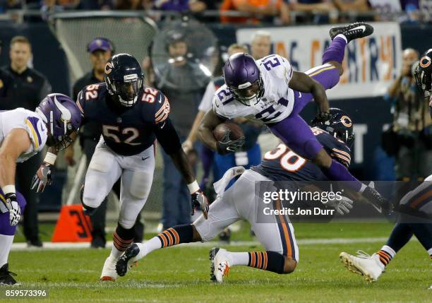 Jerick McKinnon of the Minnesota Vikings is hit by Adrian Amos of the Chicago Bears in the second quarter at Soldier Field on October 9, 2017 in...