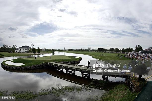 Phil Mickelson walks across the bridge leading to the 15th green during the final round of the Zurich Classic of New Orleans at the English Turn Golf...