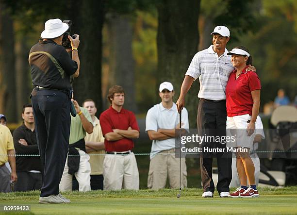 Tiger Woods poses for a photograph with playing partner Sergeant Major Mia Kelly during the AT&T National Earl Woods Memorial Pro-Am at Congressional...