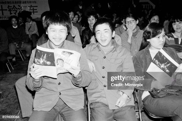 Fans, holding their programme, enjoy the performance of George Michael and Andrew Ridgeley from Wham! in China. 1985. Wham! were on a 10 day tour. In...