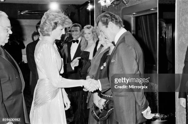 The Princess of Wales, Princess Diana greets lead actor Roger Moore at The Royal Premiere of the 14th 007 James Bond Movie, 'A View To A Kill' at the...
