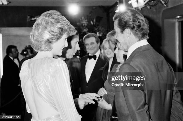 The Princess of Wales, Princess Diana talking with lead actor Roger Moore at The Royal Premiere of the 14th 007 James Bond Movie, 'A View To A Kill'...