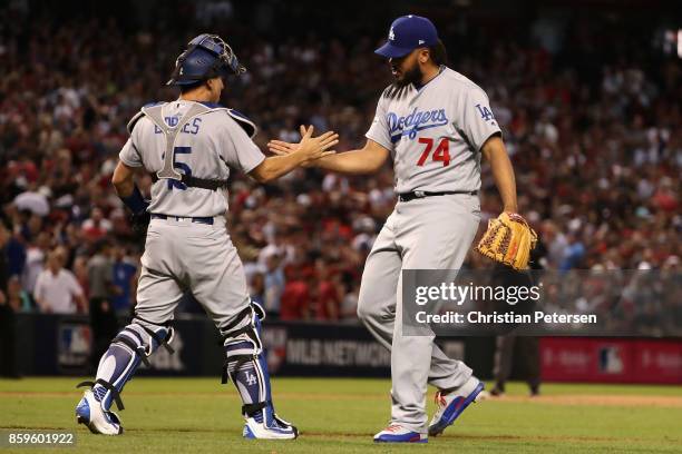 Kenley Jansen of the Los Angeles Dodgers celebrates with Austin Barnes after defeating the Arizona Diamondbacks 3-1 to win the National League...