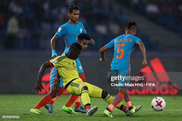 Juan Penaloza of Colombia and Sanjeev Stalin of India battle for the ball during the FIFA U-17 World Cup India 2017 group A match between India and...