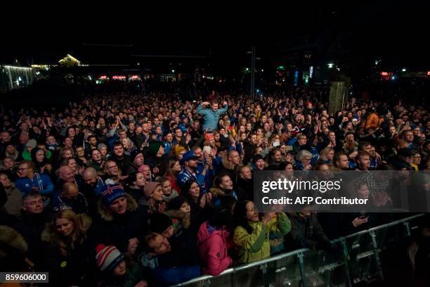 Iceland's national team football players and coaching staff celebrate with fans at Ingolfstorg square in the centre of Reykjavik after the FIFA World...