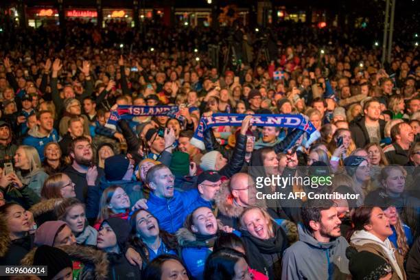 Iceland's national team football players and coaching staff celebrate with fans at Ingolfstorg square in the centre of Reykjavik after the FIFA World...