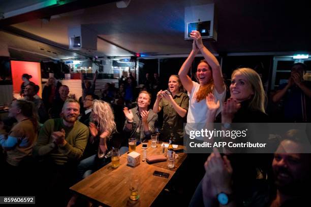 Icelandic football fans react while watching TV their national football team play during the FIFA World Cup 2018 qualification football match against...