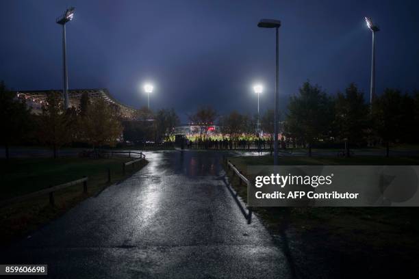 Icelandic football fans who missed out on tickets climb trees and watch between gaps in the fence their national football team play during the FIFA...