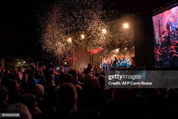 Iceland's national team football players and coaching staff celebrate with fans at Ingolfstorg square in the centre of Reykjavik after the FIFA World...