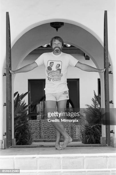 Glen Campbell at the gates of his home in Pheonix, Arizona, USA, on a hot summer's day in July 1982. See further pictures in this set that show :...