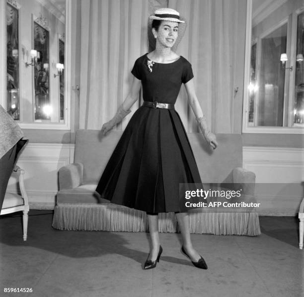 Model poses for the presentation of the first Yves Saint-Laurent's Dior collection, 04 February 1958, Avenue Montaigne in Paris. With this...