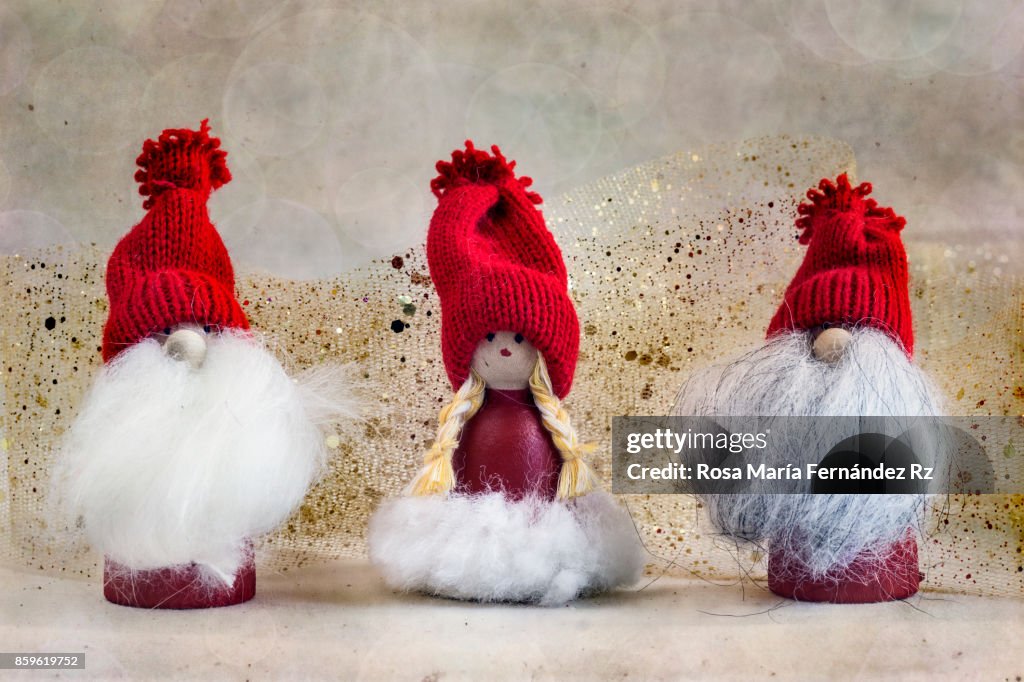 Three little christmas elves on abstract background.