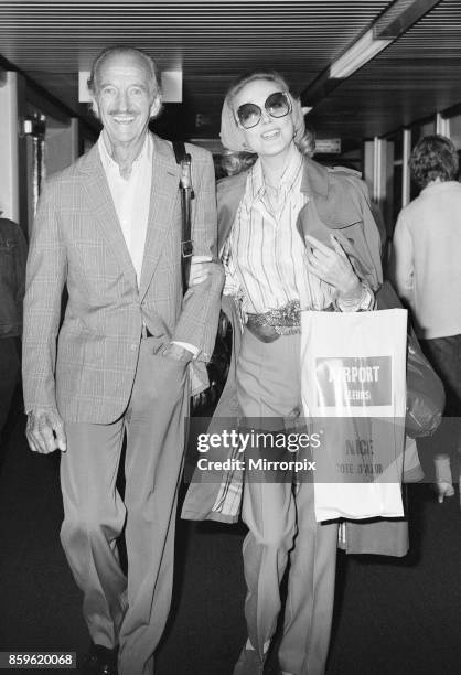 David Niven, British actor with wife Hjordis Paulina Genberg Tersmeden at London Heathrow Airport, arriving from Nice, 1st September 1982.