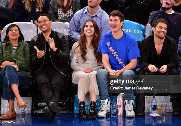 Guest, Trevor Noah, Violetta Komyshan, Ansel Elgort and Paul Wesley attend Houston Rockets Vs. New York Knicks game at Madison Square Garden on...