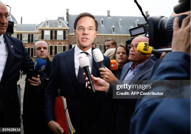 Dutch Prime Minister Mark Rutte of the liberal VVD party speaks to the press as he arrives at the Binnenhof building in The Hague on October 10,...