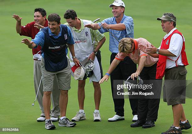 Golfers Ben Curtis , Steve Stricker , Brett Quigley , and their caddies thank the grounds crew after Curtis won the fourth and final round of the...