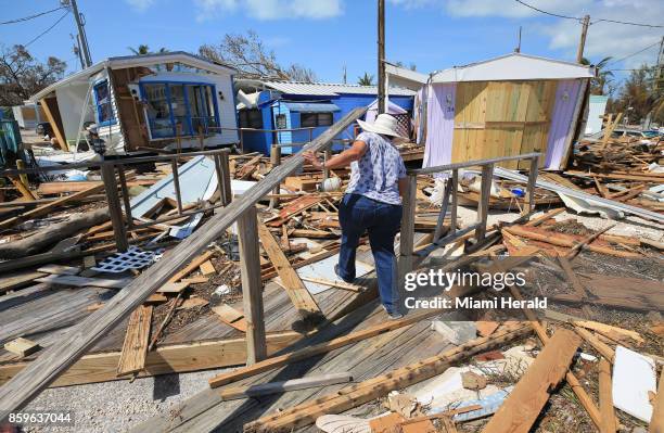 Mirta Mendez walks through the debris at the Seabreeze trailer park along the Overseas Highway in the Florida Keys on Tuesday, Sept. 12, 2017. In...