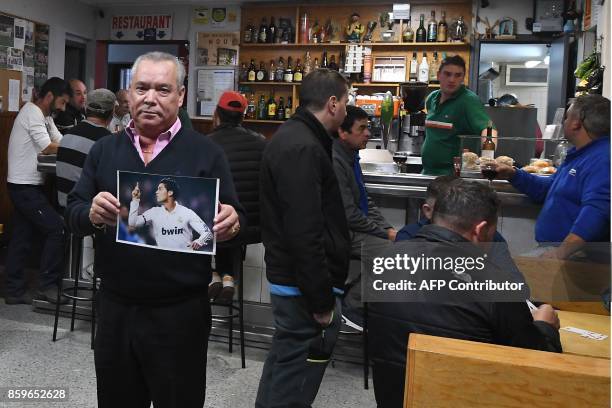 Antonio da Silva Cerqueira, President of Andorran football club "Le Futbol Club Lusitanos la Posa", poses with a photo of Cristiano Ronaldo in a bar...