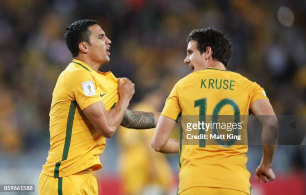 Tim Cahill of Australia celebrates with c after scoring their first goal during the 2018 FIFA World Cup Asian Playoff match between the Australian...