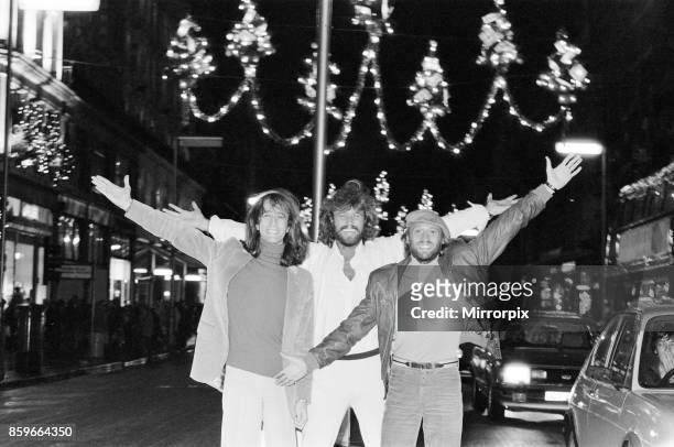 The Bee Gees check out the christmas lights in Regent Street London 22nd November 1981, From left to right: Robin Gibb Barry Gibb Maurice Gibb.