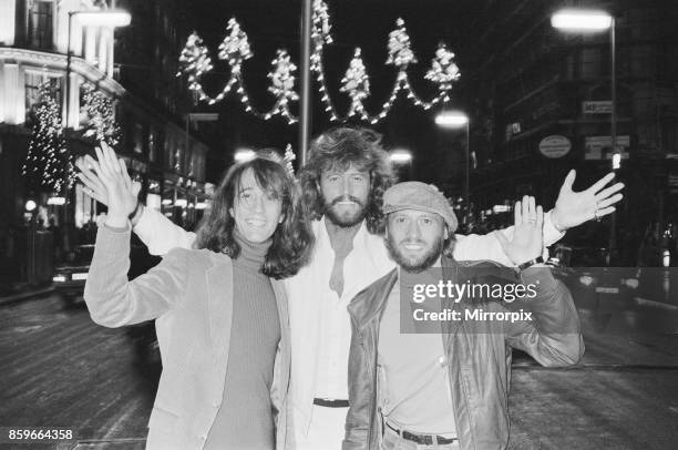 The Bee Gees check out the christmas lights in Regent Street London 22nd November 1981, From left to right: Robin Gibb Barry Gibb Maurice Gibb.