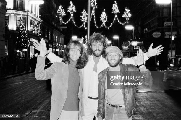 The Bee Gees check out the christmas lights in Regent Street London 22nd November 1981, From left to right: Robin Gibb Barry Gibb Maurice Gibb.