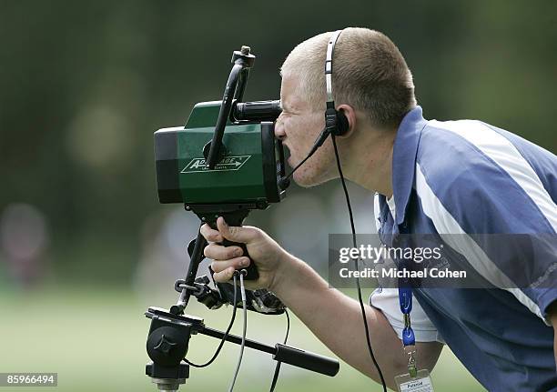 Volunteer operates a ShotLink device during the first round of the 2006 Deutsche Bank Championship held at TPC Boston in Norton, Massachusetts on...