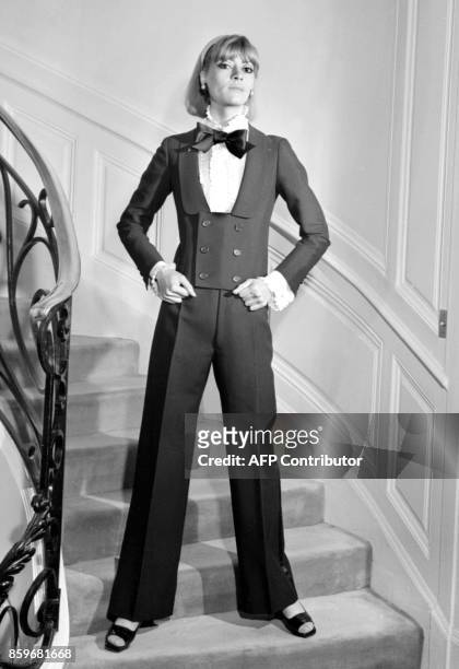 Model displays, 15 February 1967 in Paris, an alpaca dinner jacket spencer, jabot blouse and black silk bow-tie for Yves Saint Laurent 1967...