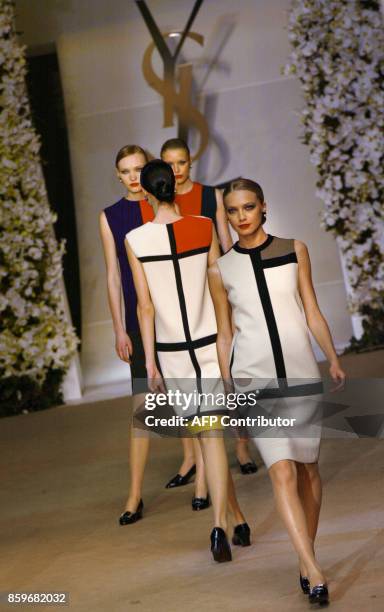 Models present dresses by French designer Yves saint-Laurent, inspired in 1965 by the work of Dutch painter Piet Mondrian 22 January 2002, during...