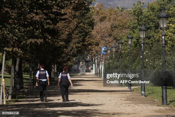 Members of the Catalan police Mossos d'Esquadra patrol the Parc de la Ciutadella which houses the Catalan regional parliament in Barcelona on October...