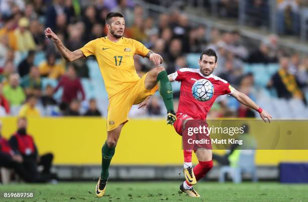 Nikita Rukavytsya of Australia is challenged by Fahad Youssef of Syria during the 2018 FIFA World Cup Asian Playoff match between the Australian...